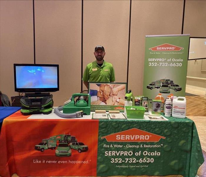 Mike Webb standing behind SERVPRO table