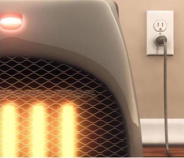 photo of space heater up close showing the cord plugged in and the elements red hot
