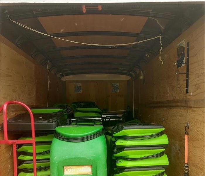 Picture of enclosed trailer loaded with equipment for storm damage to include air movers and dehumidifiers.