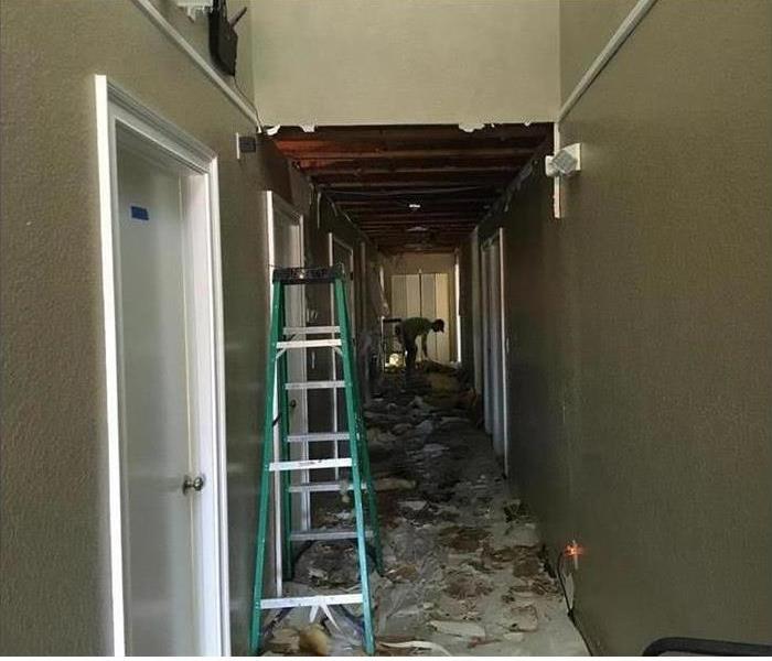 Ceiling falling in a hallway due to water damage
